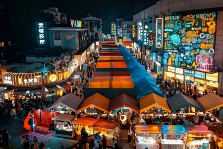 View of Wulin Night Market with colorful food stalls and glowing neon signs in Hangzhou