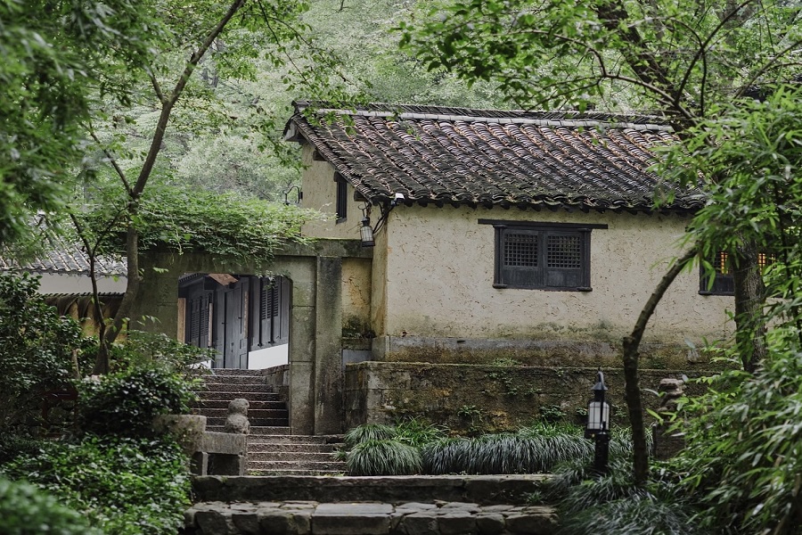 Quiet old earthen tile house hidden among green bamboo and trees in tranquil Amanfayun ancient village near Lingyin Temple
