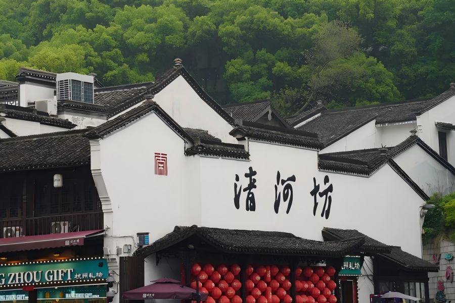 Hefang Street (Qinghefang) in Hangzhou featuring time-honored Southern Song ancient pedestrian street with antique shops, local snacks, traditional Chinese medicine stores and red lantern-lit historic architecture at the foot of Wushan Mountain