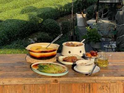 Outdoor terrace meal beside Longjing tea fields at Longding Building
