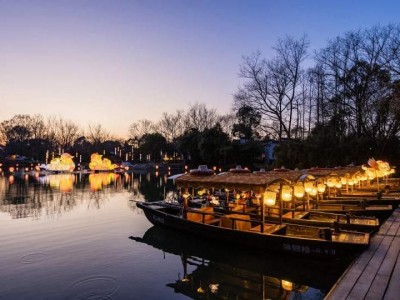 Lit wooden cruise boats at West Lake dock